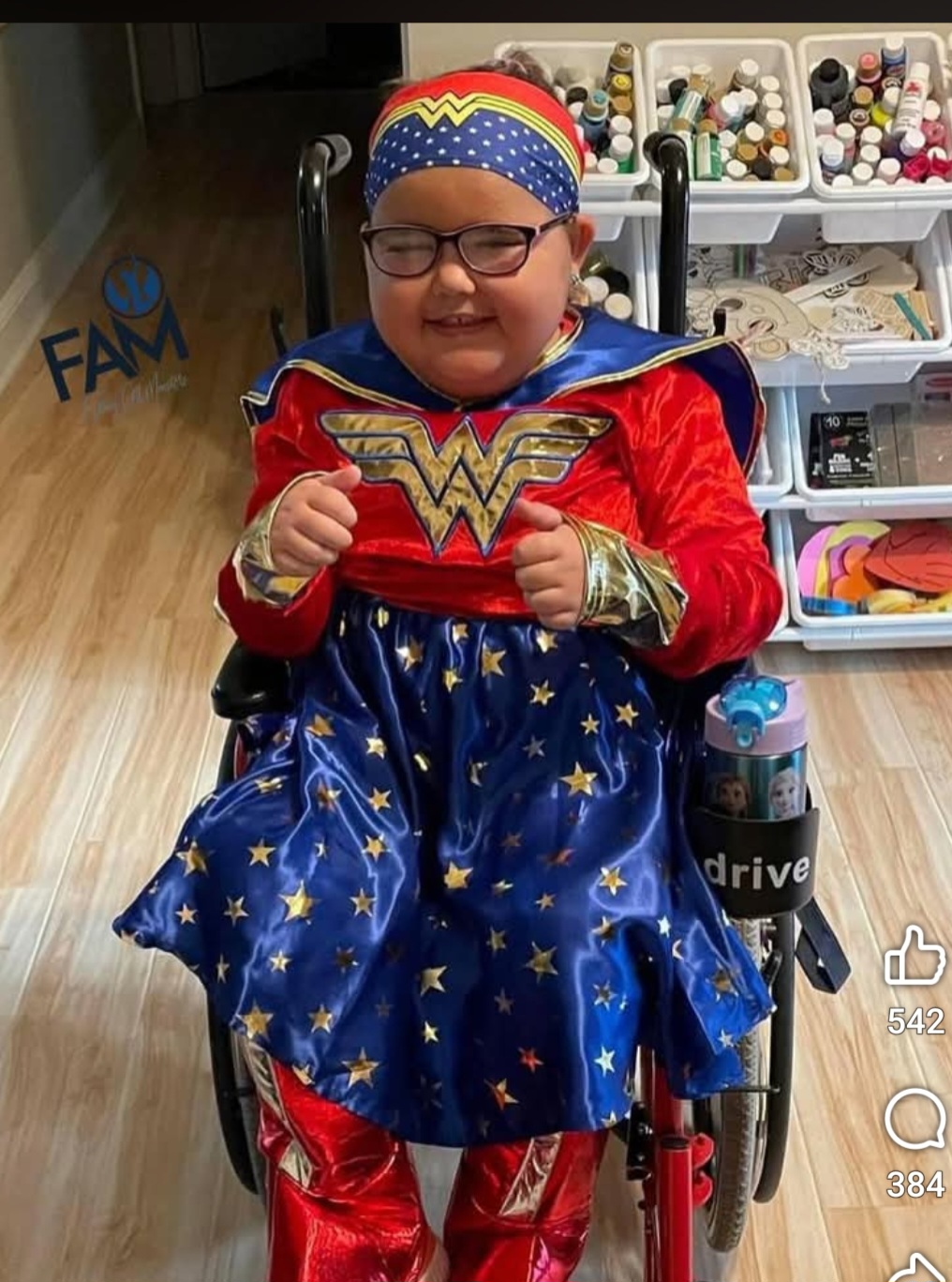 Brynnley smiling in her Wonder Woman superhero costume